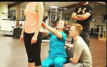Fitness rehabilitation team discussing client progress and movement planning